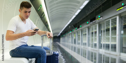 Passenger reading phone in subway