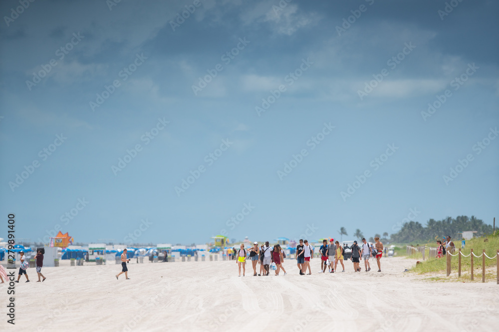 Group of young poeple walking on Miami Beach summer 2019