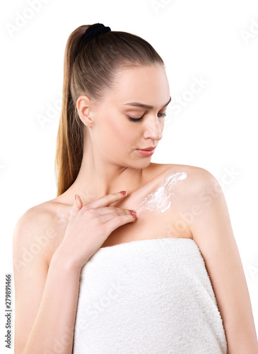 Woman applying cosmetic cream on a body