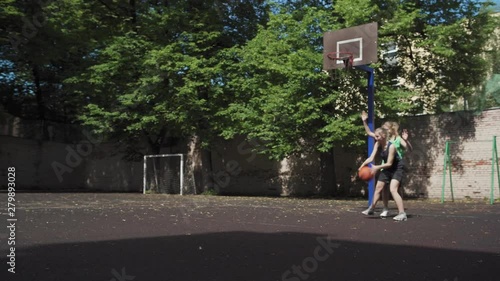 Wallpaper Mural Wide shot of two active female friends playing basketball together on outdoor urban court. Girl making successful shot into hoop and scoring goal Torontodigital.ca