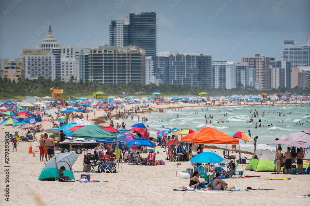 Tourists on Miami Beach. Getting ready for a day at the beach Tourists on Miami Beach. Getting ready for a day at the beach