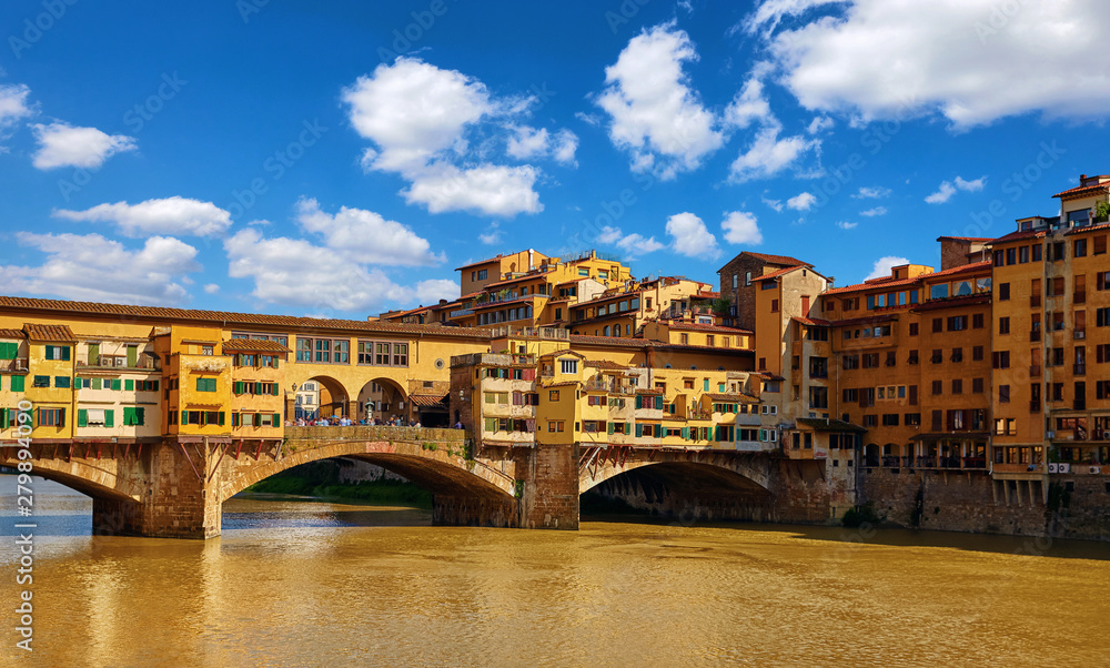 Panorama view to ancient bridge Ponte Vecchio at river Arno in Florence old town, famous touristic place of Tuscany region, Italy.