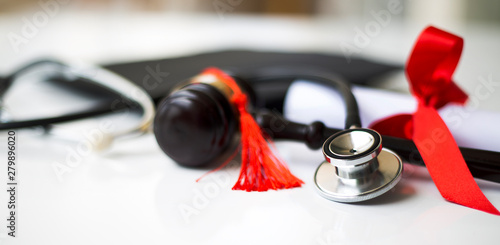 Black graduation cap, degree and stethoscope 