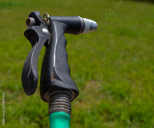 Wallpaper Mural Water hose sprayer attached to a green hose Torontodigital.ca