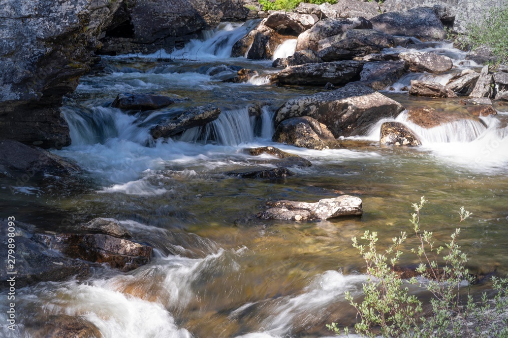 Naklejka premium River over rocks