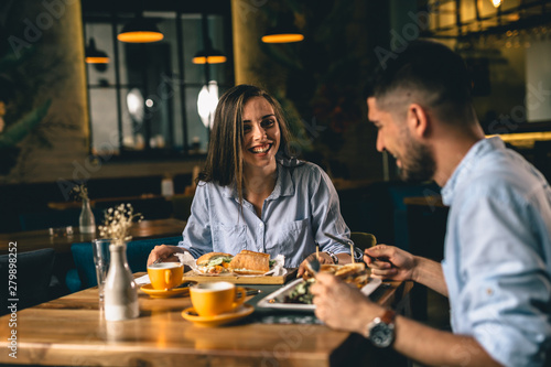 A happy young couple on a date at a fancy restaurant