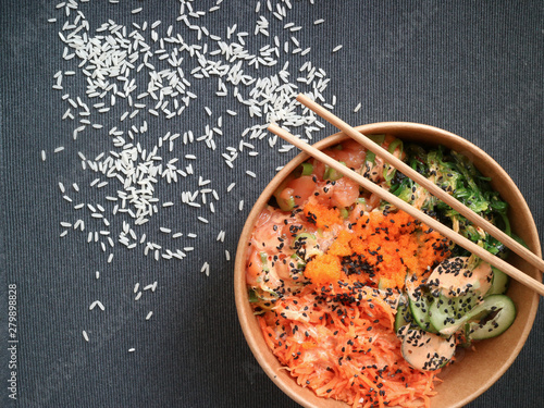 Poke with a grey backgraound and some grains of rice photo