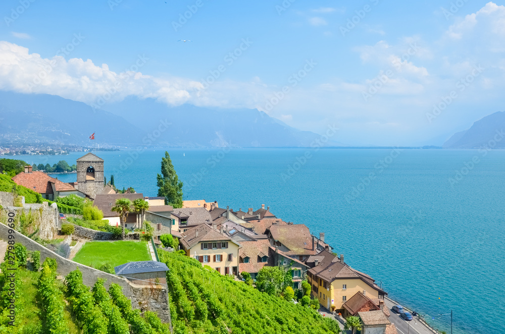 Picturesque village St. Saphorin in Lavaux wine region, Switzerland. Terraced vineyards on slopes by beautiful Geneva Lake, in French Lac Leman. Travel destinations