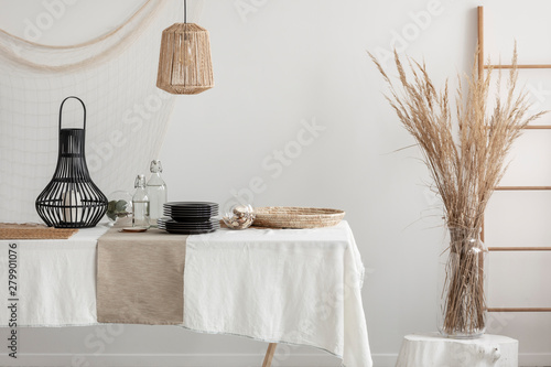 Close-up of table with white linen tablecloth and beige napkin photo