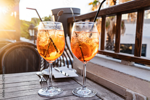 Wallpaper Mural Two wine glass of cold cocktail Aperol spritz on background of restaurant. Traditional Italian Aperitif Cocktail concept Torontodigital.ca