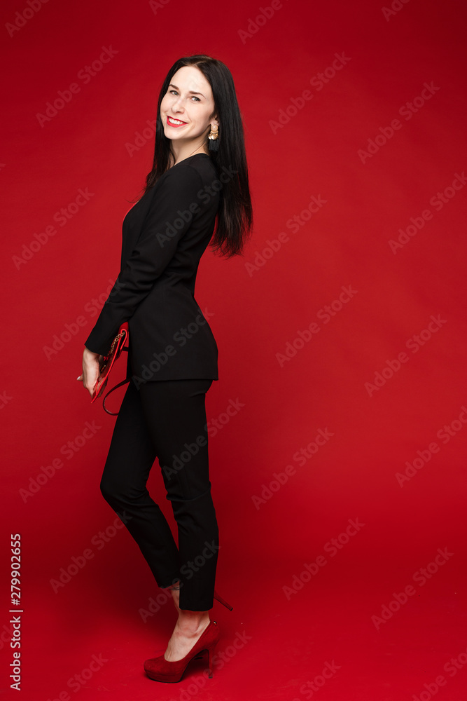 Portrait of young beautiful woman thoughtfully looking down. Brunette model in elegant costume posing at camera . Pretty lady in red sunglasses leaning one hand on other and holding it near face. Portrait of young beautiful woman thoughtfully looking down. Brunette model in elegant costume posing at camera . Pretty lady in red sunglasses leaning one hand on other and holding it near face.
