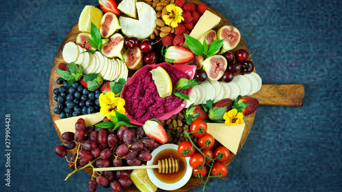Fotografie, Obraz Cheese and fruit charcuterie dessert grazing platter on wooden board overhead