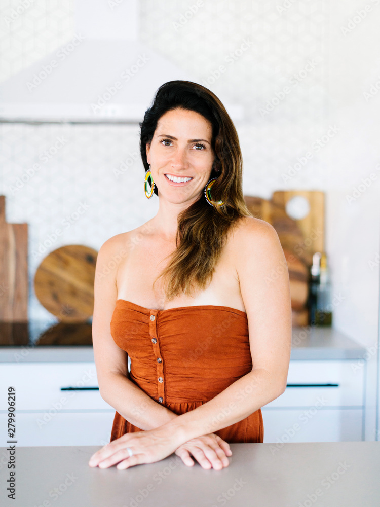 Mid adult woman smiling in kitchen Mid adult woman smiling in kitchen