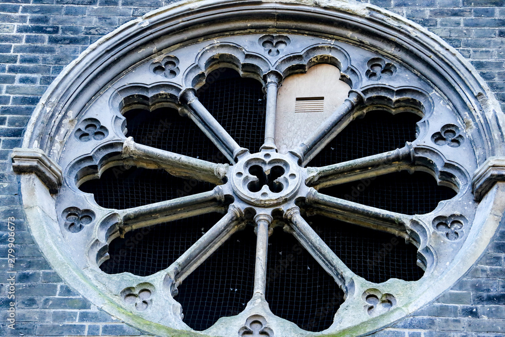 Fototapeta premium A rare example of a naturalistic ten-part rose window in Abney Park Cemetery church. The church is the oldest non denominational church in Europe and one of London's magnificent seven graveyards.