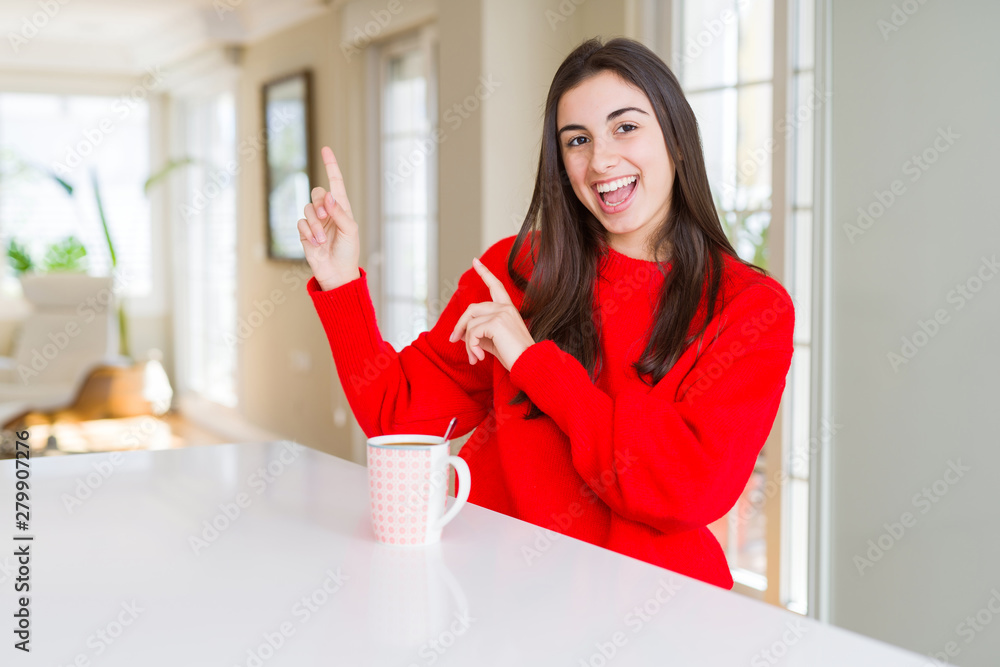 Beautiful young woman drinking a cup of black coffee smiling and looking at the camera pointing with two hands and fingers to the side. Beautiful young woman drinking a cup of black coffee smiling and looking at the camera pointing with two hands and fingers to the side.