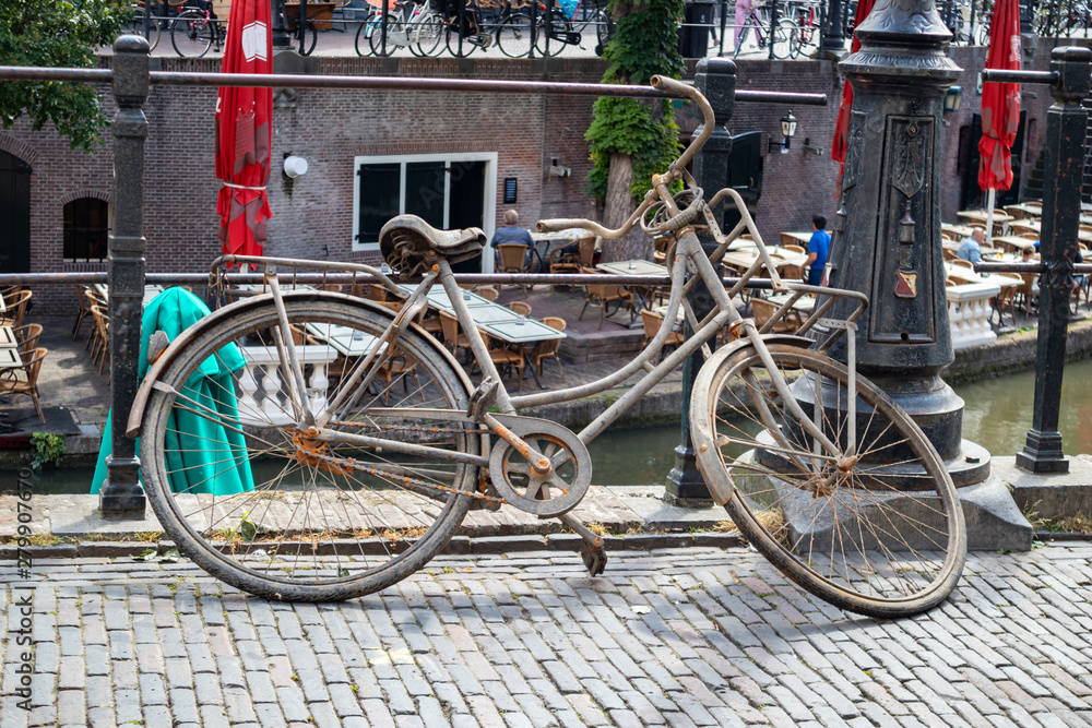 Rusty bicycle. Old bike on a river canal in Utrecht city, Netherlands