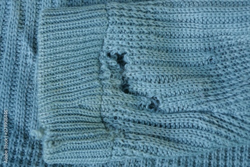 one torn gray wool sleeve on a piece of old clothes