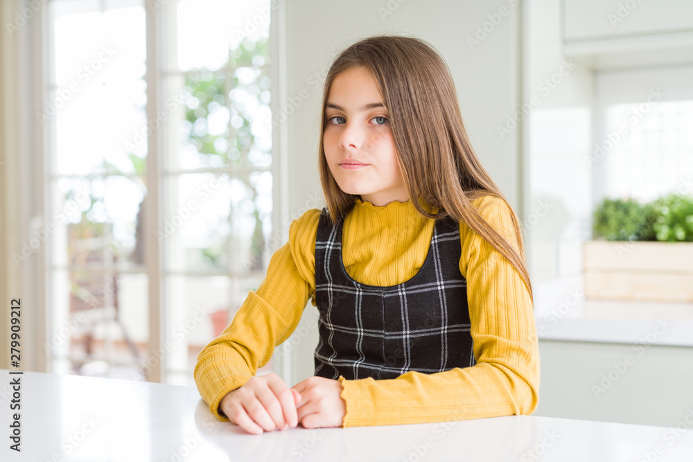 Young beautiful blonde kid girl wearing casual yellow sweater at home skeptic and nervous, frowning upset because of problem. Negative person.