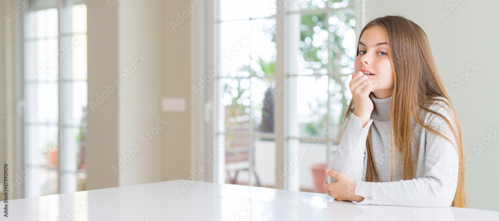 Wide angle picture of beautiful young girl kid wearing casual sweater looking confident at the camera with smile with crossed arms and hand raised on chin. Thinking positive.