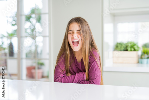 Beautiful young girl kid on white table with hand on stomach because indigestion, painful illness feeling unwell. Ache concept. Free Download Beautiful young girl kid on white table with hand on stomach because indigestion, painful illness feeling unwell. Ache concept. - GFXLoad