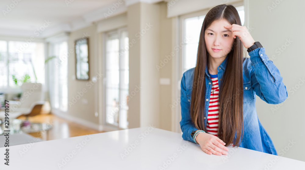 Young beautiful asian woman with long hair wearing denim jacket pointing unhappy to pimple on forehead, ugly infection of blackhead. Acne and skin problem Young beautiful asian woman with long hair wearing denim jacket pointing unhappy to pimple on forehead, ugly infection of blackhead. Acne and skin problem