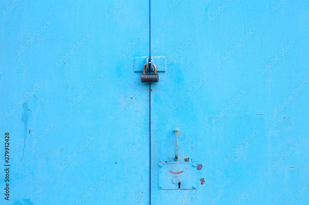 metal blue door with padlock. Old garage gates with keyhole metal blue door with padlock. Old garage gates with keyhole