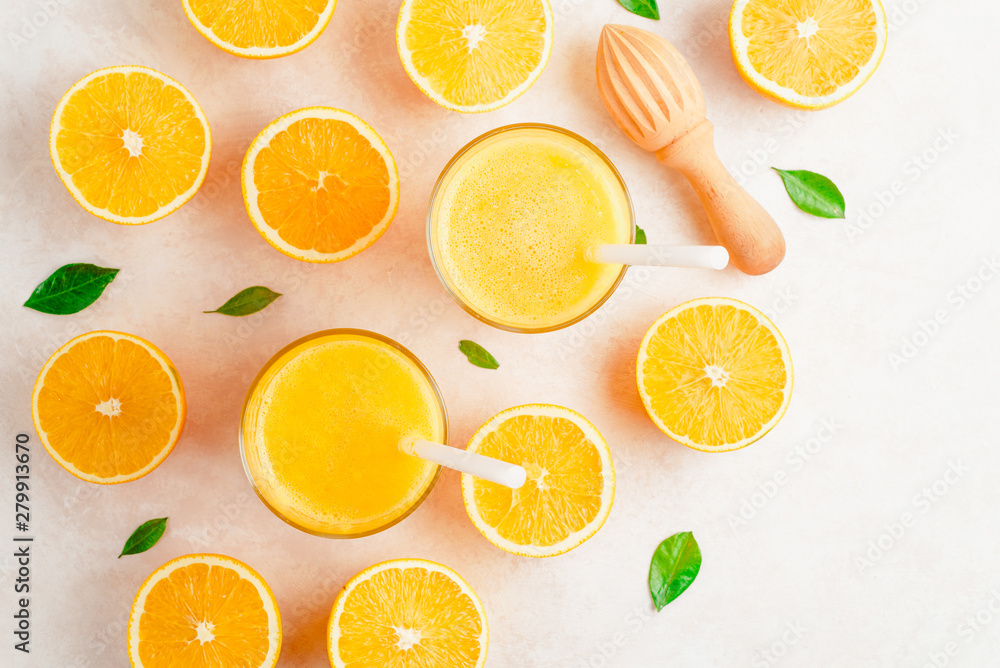 Fresh Orange juice in glass and fresh citrus around. Healthy drink on white. Top view. Fresh Orange juice in glass and fresh citrus around. Healthy drink on white. Top view.