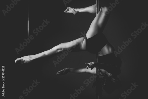 silhouette of pole dancer woman in action.
