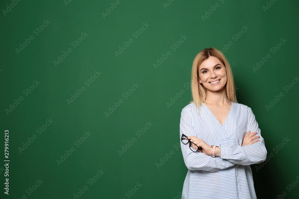 Portrait of beautiful teacher near chalkboard, space for text Portrait of beautiful teacher near chalkboard, space for text