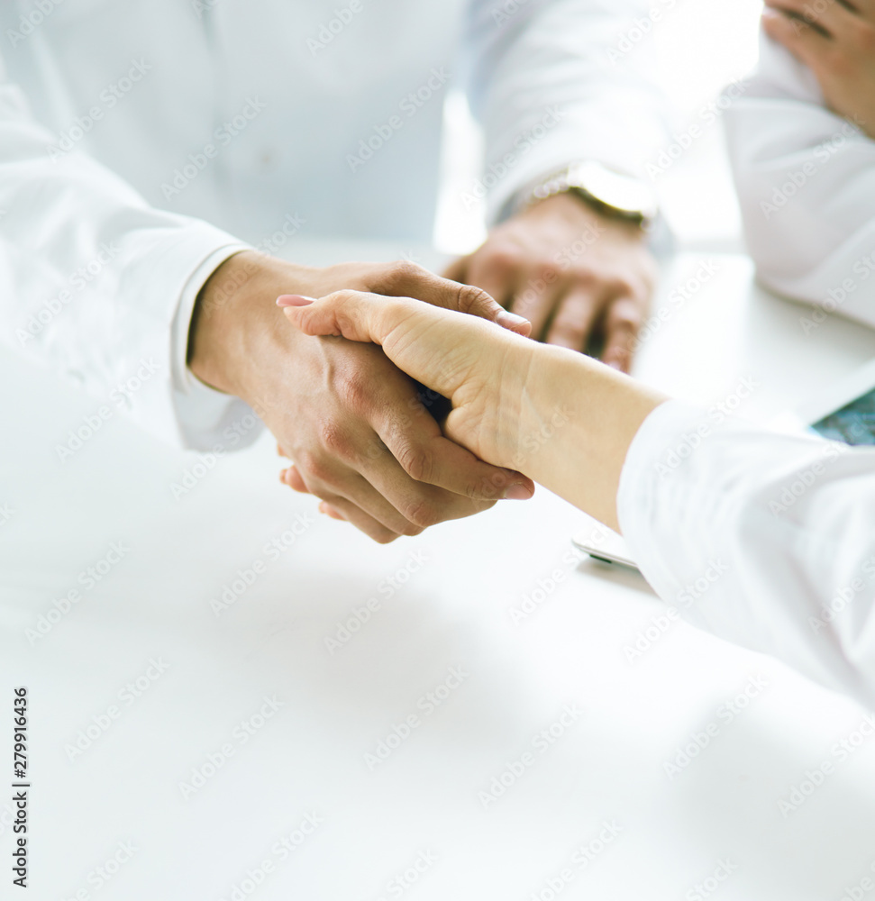 Team of doctors putting hands together, closeup Team of doctors putting hands together, closeup