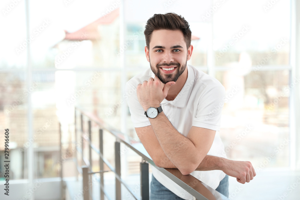 Fototapeta premium Portrait of handsome man smiling in light room
