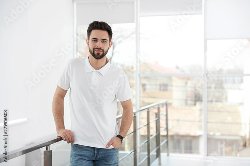 Portrait of handsome man in light room