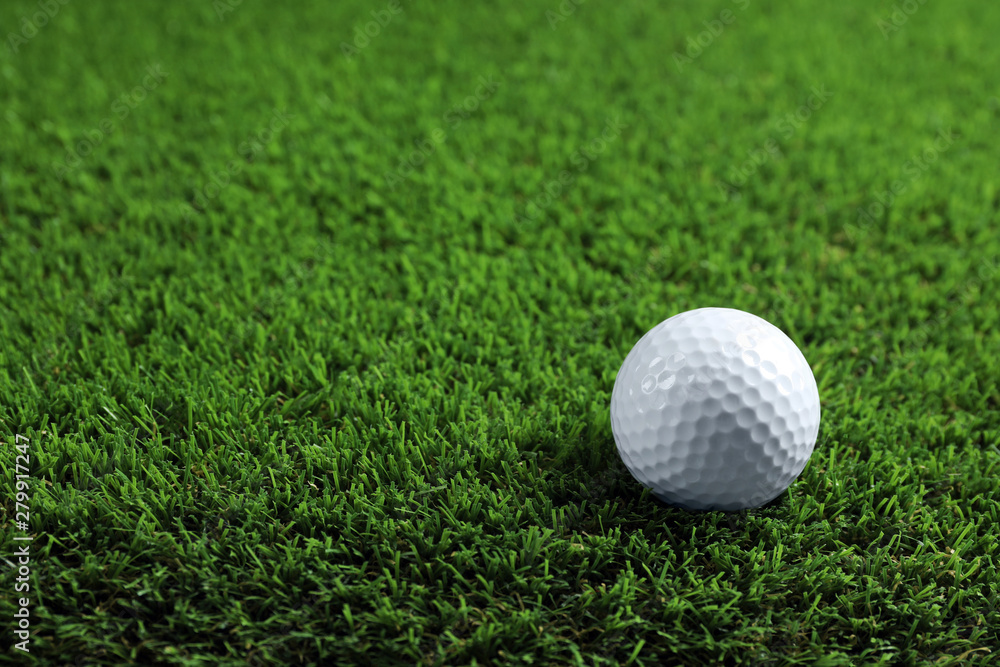 Golf ball on green grass. Space for text Golf ball on green grass. Space for text