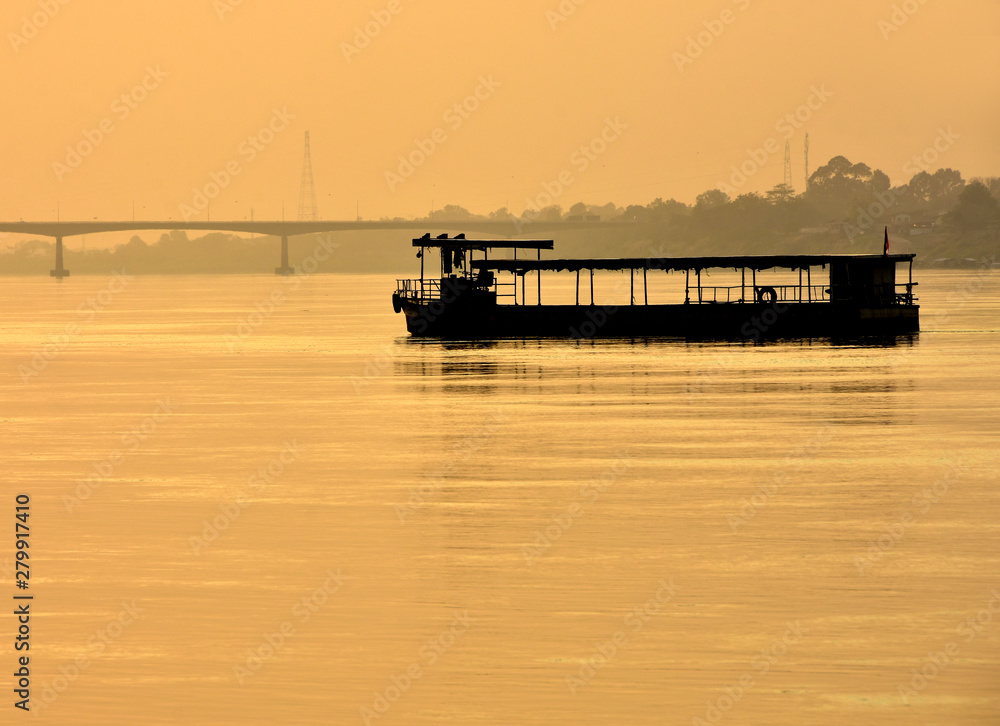 sunset on river,Ferry in the Mekong River at Nong Khai, Thailand