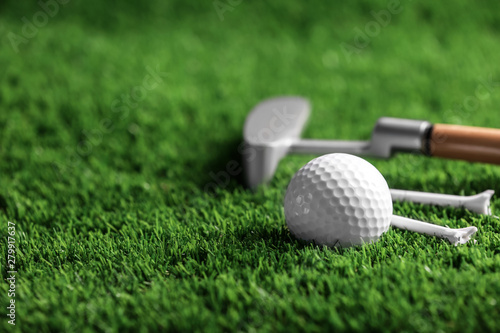 Set of golf equipment on artificial grass, space for text