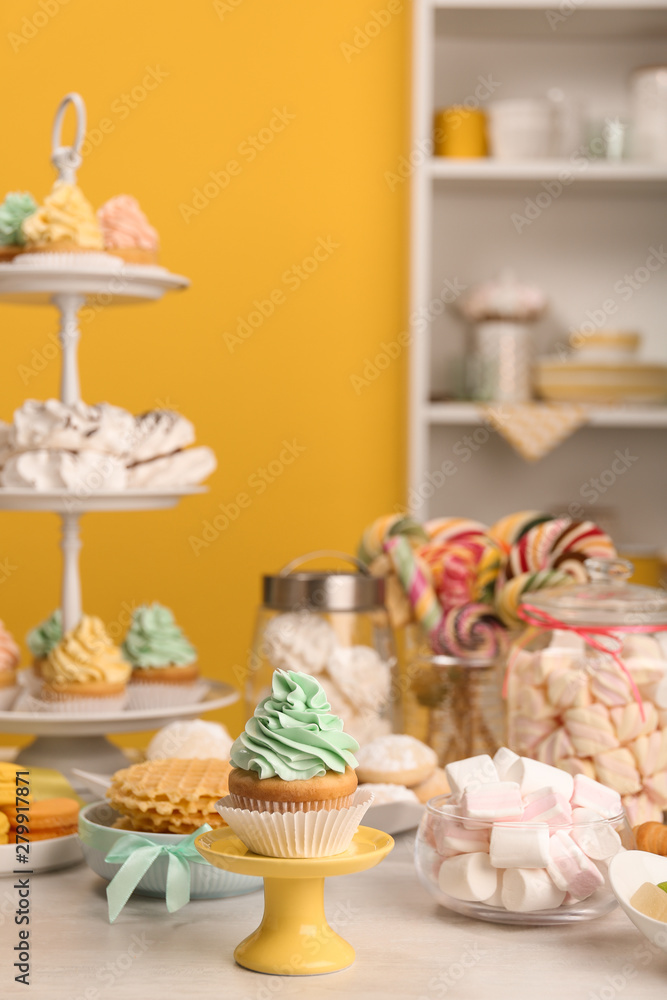 Table with different sweets in room. Candy bar for party