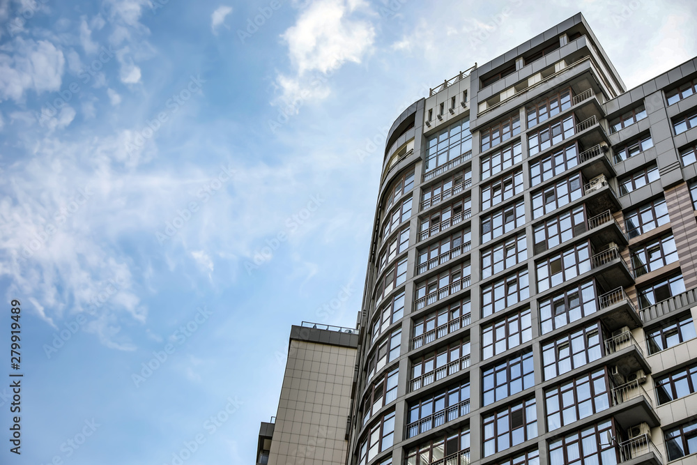 Modern building with tinted windows against sky, low angle view. Urban architecture Modern building with tinted windows against sky, low angle view. Urban architecture