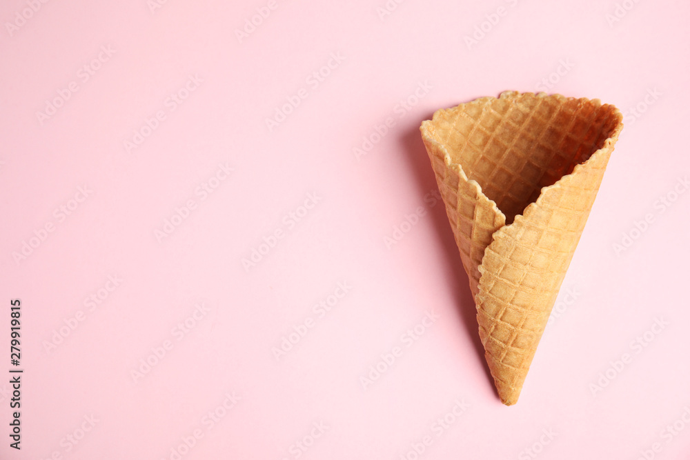 Empty wafer ice cream cone on pink background, top view. Space for text Empty wafer ice cream cone on pink background, top view. Space for text