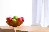 Bowl of fresh apples on table indoors. Space for text