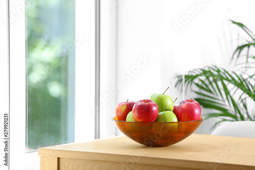 Bowl of fresh apples on table indoors. Space for text