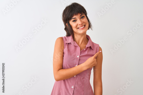 Young beautiful woman wearing red summer shirt standing over isolated white background cheerful with a smile of face pointing with hand and finger up to the side with happy and natural expression 