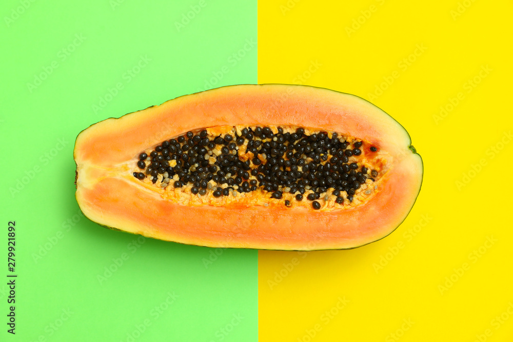 Fresh juicy halved papaya on color background, top view Fresh juicy halved papaya on color background, top view