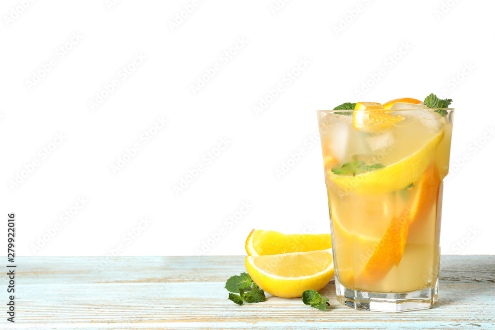 Fototapeta premium Glass of citrus refreshing drink on wooden table against white background