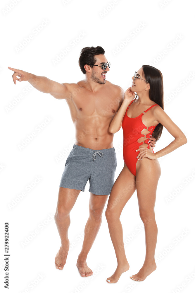 Young attractive couple in beachwear and sunglasses on white background Young attractive couple in beachwear and sunglasses on white background