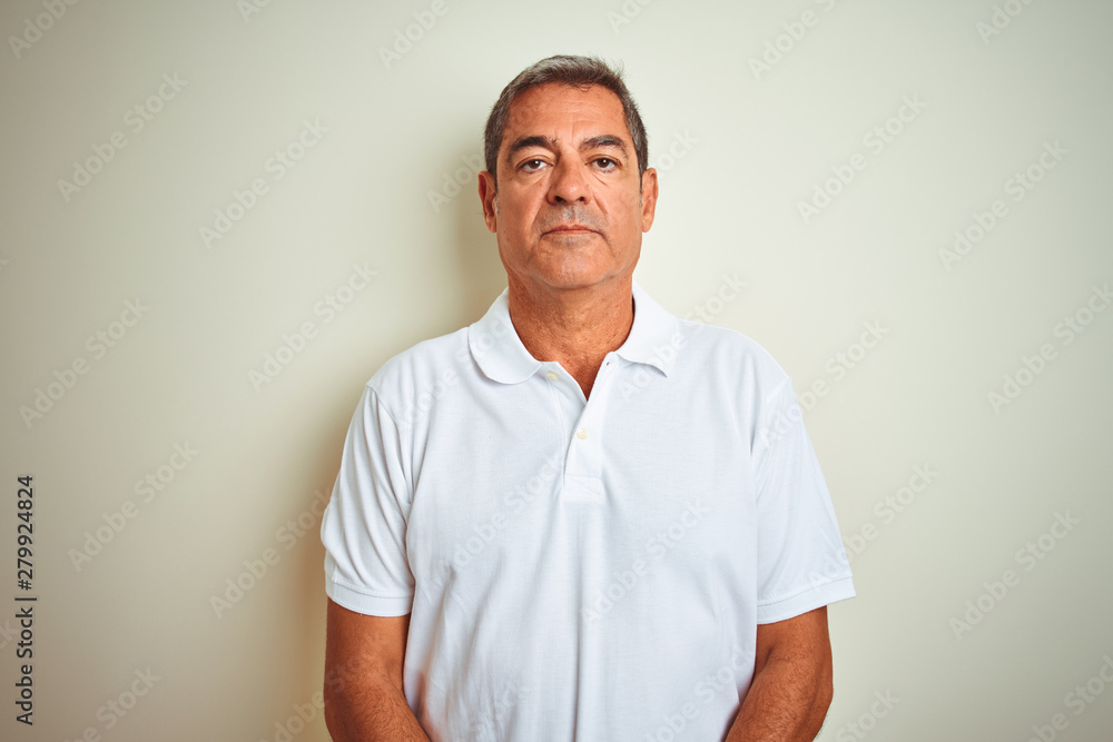 Handsome middle age man wearing polo standing over isolated white background with serious expression on face. Simple and natural looking at the camera. Handsome middle age man wearing polo standing over isolated white background with serious expression on face. Simple and natural looking at the camera.