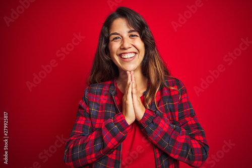 Young beautiful woman wearing casual jacket standing over red isolated background Suffering of neck ache injury, touching neck with hand, muscular pain © Krakenimages.com