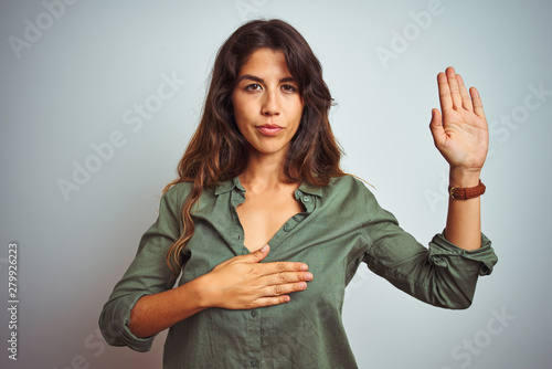 Photography Young beautiful woman wearing green shirt standing over grey isolated background