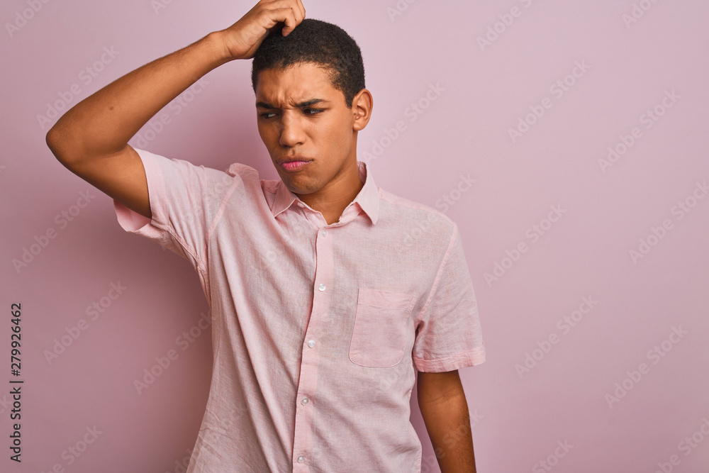 Young handsome arab man wearing casual shirt standing over isolated pink background confuse and wonder about question. Uncertain with doubt, thinking with hand on head. Pensive concept. Young handsome arab man wearing casual shirt standing over isolated pink background confuse and wonder about question. Uncertain with doubt, thinking with hand on head. Pensive concept.