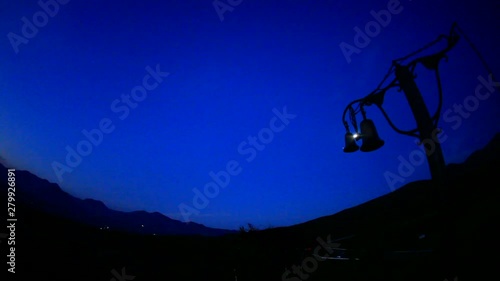 Bells at dawn with mountains in background photo