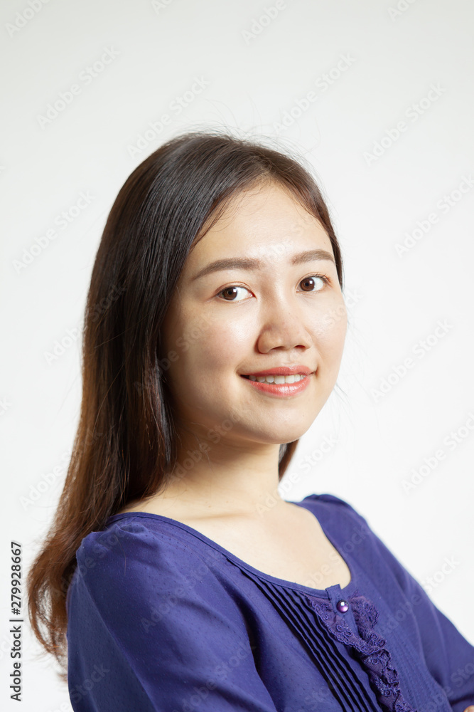 Portrait photograph of smart and good looking Asian woman in the blue shirt close up on white background. Studio lighting set up. Portrait photograph of smart and good looking Asian woman in the blue shirt close up on white background. Studio lighting set up.